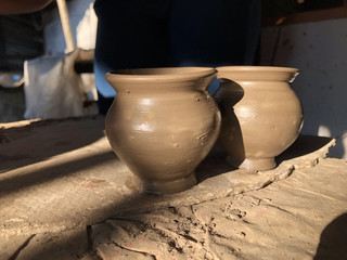 Fototapeta na wymiar potter teaches his craft to child