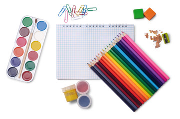 Naklejka premium Colored pencils, grid notepad, watercolor paints, gouache, erasers, pencil sharpener, paper clips isolated on white background. School stationery.