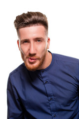 Obraz premium Attractive young man wearing blue shirt, isolated over a white background.