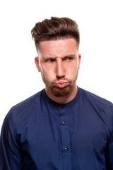 Fototapeta premium Attractive young man wearing blue shirt, isolated over a white background.
