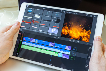 White plane in hand. On-screen video editing program