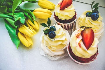 Cupcakes in shape of number 8 with tulip flowers on pink pastel background. International Women's Day concept, March 8.