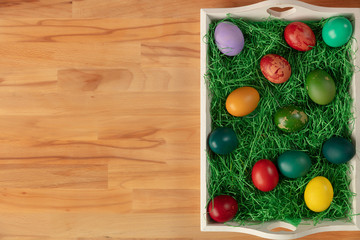 Naklejka na ściany i meble Top view of colorful easter eggs in tray