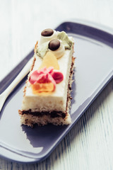 A slice of sponge cake on a rectangular plate.