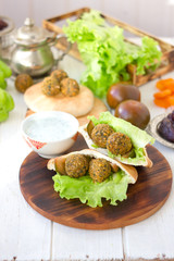 Falafel with lettuce and vegetables in pita bread.