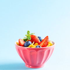 Gluten free breakfast with berries,natural yogurt and corn flakes.