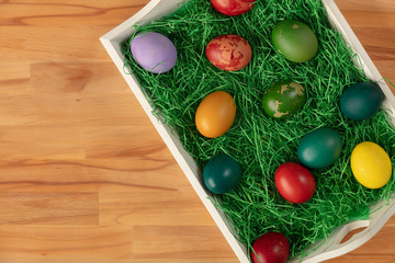 Top view of colorful easter eggs in tray