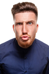 Fototapeta premium Attractive young man wearing blue shirt, isolated over a white background.