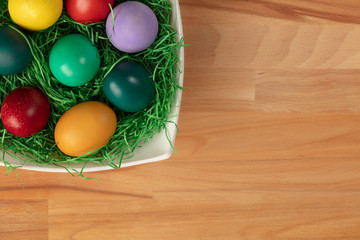 Top view of colorful easter eggs in pot