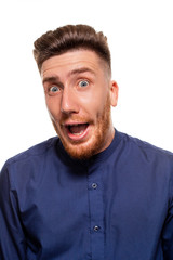 Obraz premium Attractive young man wearing blue shirt, isolated over a white background.