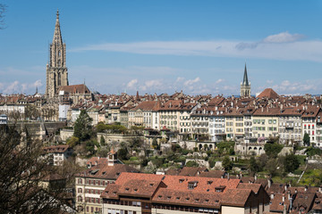 Fototapeta premium Bern skyline with the Cathedral and houses from the old town on a cliff on a sunny day in Switzerland capital city