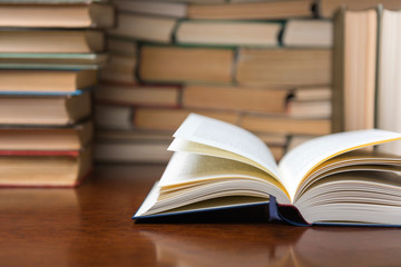 open book on the table against the background of books