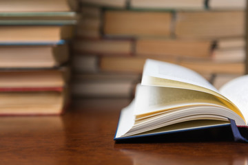 open book on the table against the background of books