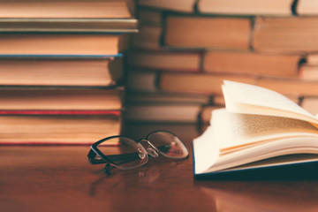 open book on the table against the background of books