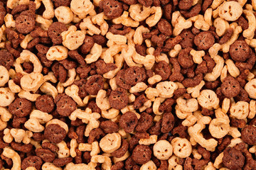  Chocolate flakes in the form of skulls and bones background. Top view.