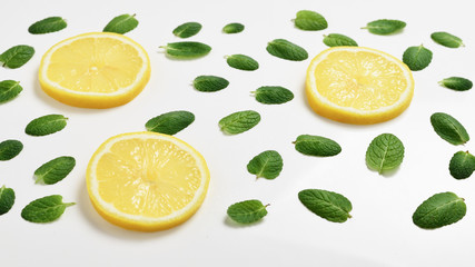 Mint leaves am lemon slices on white background