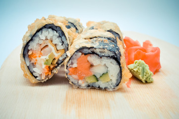 hot homemade roll tempura shrimp and avocado lying next to the ginger, the concept of home Asian-inspired dinner.