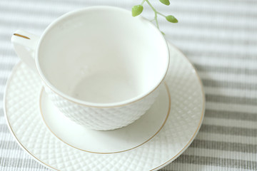  white empty  cup on a   tablecloth. Kitchen equipment top view