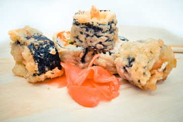 hot homemade roll tempura shrimp and avocado lying next to the ginger, the concept of home Asian-inspired dinner.