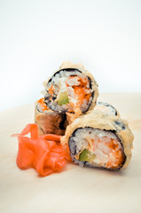 hot homemade roll tempura shrimp and avocado lying next to the ginger, the concept of home Asian-inspired dinner.