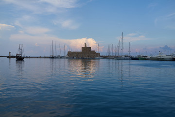 Fototapeta na wymiar Fort St. Nicholas in the port of the city of Rhodes Greece