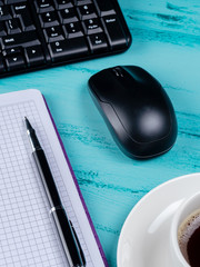 Office table desk. Workspace with note book, keyboard, office supplies and coffee cup on wooden...