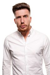 Obraz premium Studio photo of a good-looking man in a white shirt, isolated over a white background