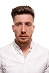 Fototapeta premium Studio photo of a good-looking man in a white shirt, isolated over a white background