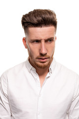 Obraz premium Studio photo of a good-looking man in a white shirt, isolated over a white background