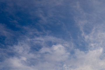 Blue sky with clouds and sun reflection in water with place for your text. blue sky background with white clouds