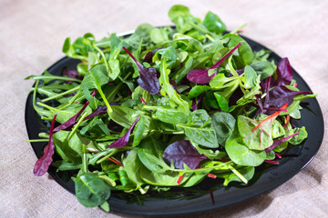 Fresh lettuce leaves on a kitchen table.