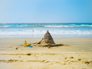 Fototapeta na wymiar Sand castle made by children at the beach