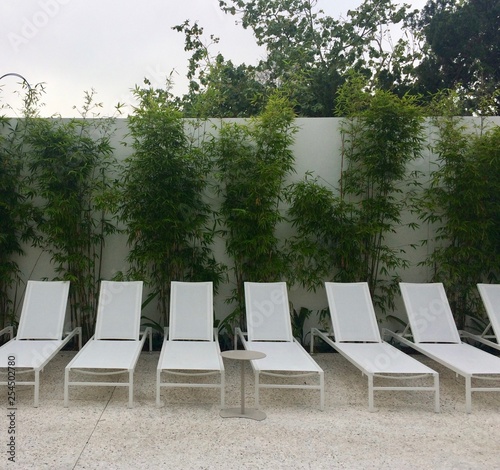 Pool Chairs With Bamboo Background Stock Photo And Royalty