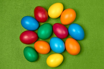 Easter eggs multicolored on green background Top view