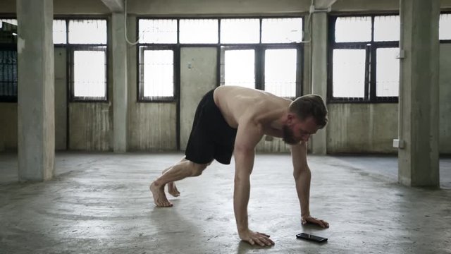 Shirtless man doing push up variations