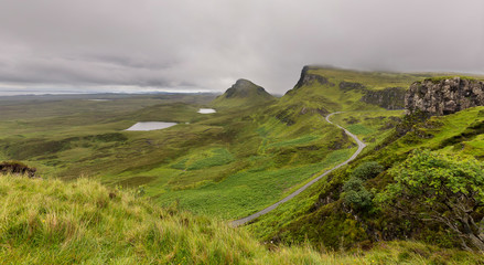 Landscape of the Quiraing Mountains and road in Isle of Skye with dark clouds