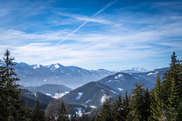 View over forest in Kaiserau to mountains Rottenmanner Tauern Dachstein