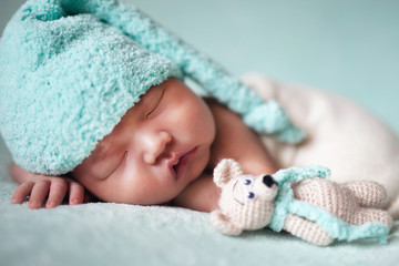 newborn baby asian boy sleeping at blue background