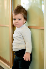 Closeup indoor portrait of a baby boy with naughty hair. The various emotions of a child are...