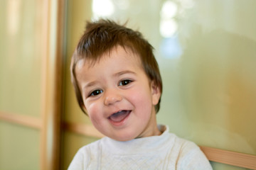 Closeup indoor portrait of a baby boy with naughty hair. The various emotions of a child are...