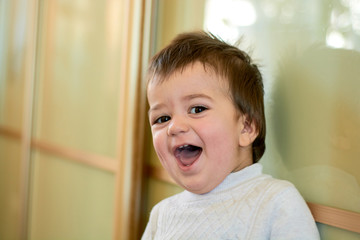 Closeup indoor portrait of a baby boy with naughty hair. The various emotions of a child are...