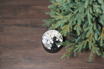 Christmas tree. Linoleum in the form of laminate. Black round box with Christmas decorations. Round...