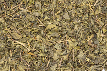 Lot of pieces of dry green tea closeup flatlay isolated