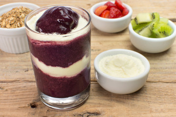 Brazilian acai with baby milk  and fruits in wood background