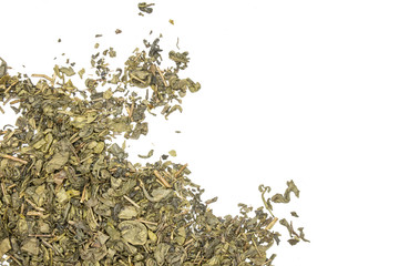 Lot of pieces of dry green tea left cornern below flatlay isolated on white background