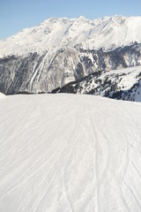 Empty ski slope in French alps in winter 