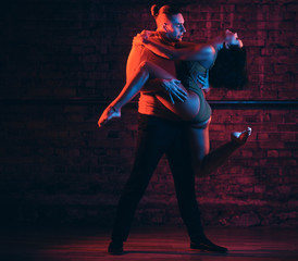 Passionate couple perform incendiary dance in night club