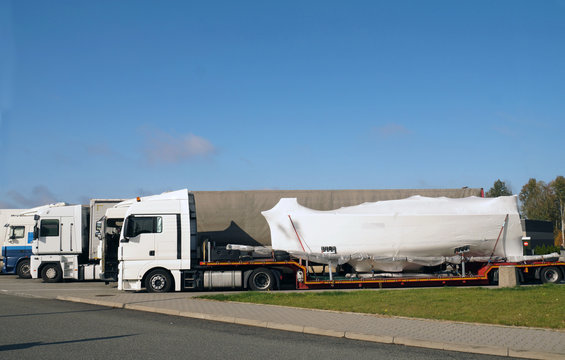 Truck With A Special Trailer For Boat Transport. Land Transport Of Boats And Yachts.