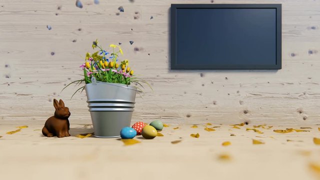 Easter eggs and chocolate rabbit near a flower bucket and flat screen tv
