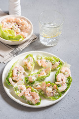 Shrimp salad wraps in lettuce leaves on a holiday table
